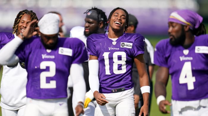 Minnesota Vikings wide receiver Justin Jefferson, center, smiles while taking part in a joint practice with the San Francisco 49ers during NFL football training camp in Eagan, Minn., Thursday, Aug. 18, 2022.
